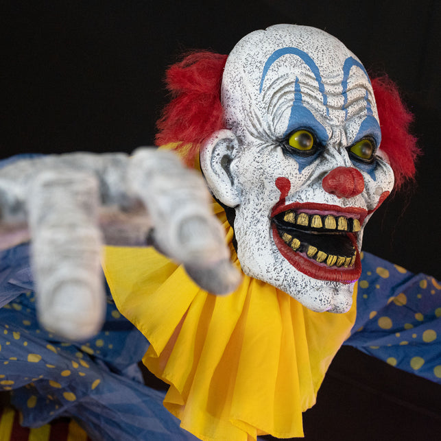 Close-up clownsgezicht met blauwe boogjes, gele ogen, rode bolneus en rode haarplukken