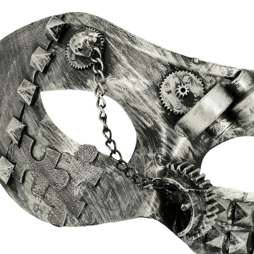 Detail van het steampunk oogmasker: puzzelstuk, klinknagels en kettinkje bij de oogopening