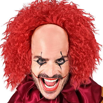 Enge clownspruik rood gedragen bij een horrorclownlook met zwarte oogschmink