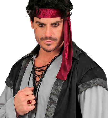 Gouden ring met rode steen aan de hand van een heer in piratenoutfit