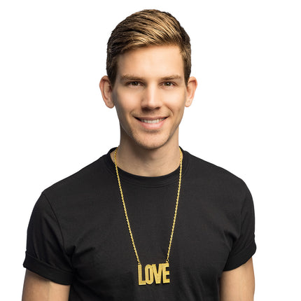 Ketting 'Love' goud gedragen door een heer over een zwart T-shirt