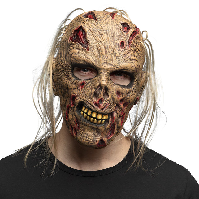 Latex hoofdmasker Zombie Grumble met blonde haarlokken en gele tanden, gedragen voor Halloween