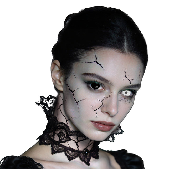 Mini sclera Eclipse contactlenzen gedragen, met één wit en één zwart oog in een bleek gezicht