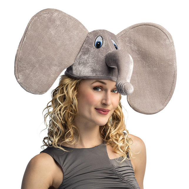 Muts olifant in grijs plush met grote flaporen en opstaande slurf, gedragen door een vrouw op carnaval