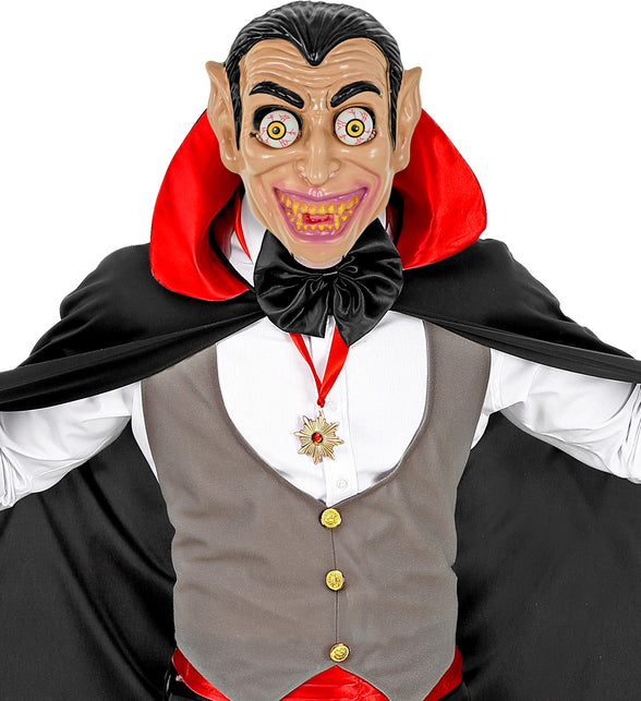 Vampiermasker met wiebelende ogen gedragen bij een cape en strik op een Halloweenfeest