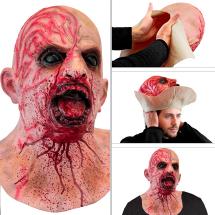 Zombie hoofdmasker zijaanzicht en het oprekken van het latex om over je hoofd te schuiven
